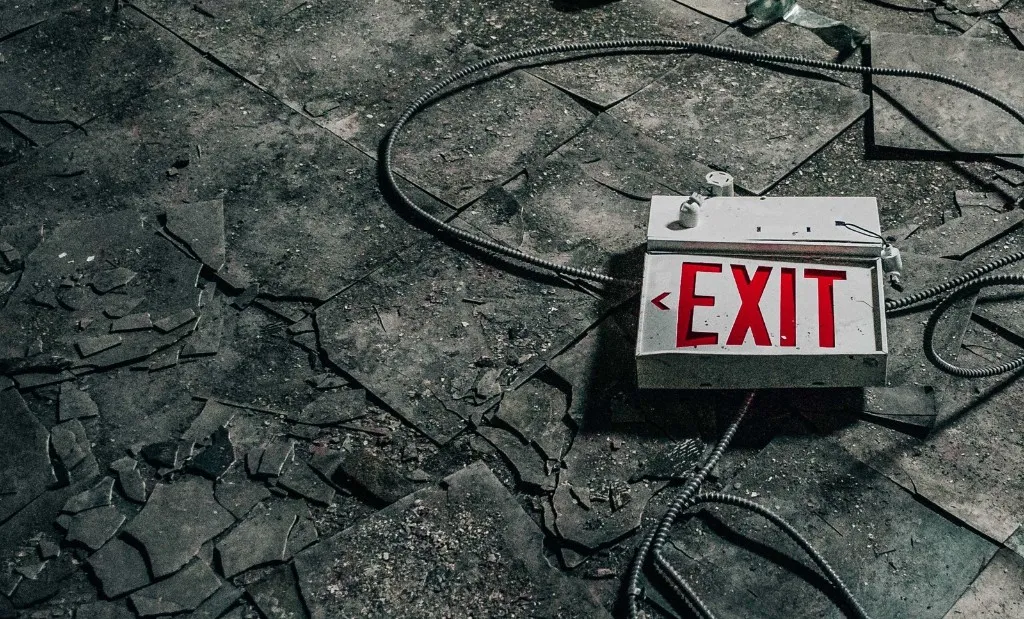 Dead Air — abandoned set with broken EXIT sign