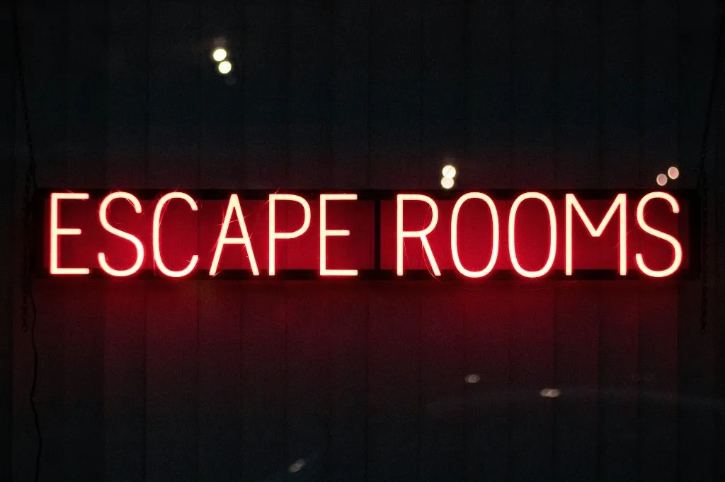 Glowing red neon sign reading Escape Rooms